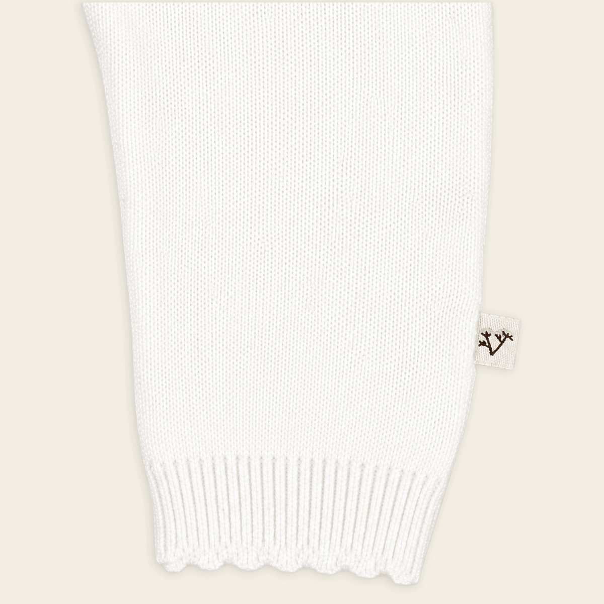 detail of sleeve for dove white floral embroidered knit baby jumpsuit made with organic cotton