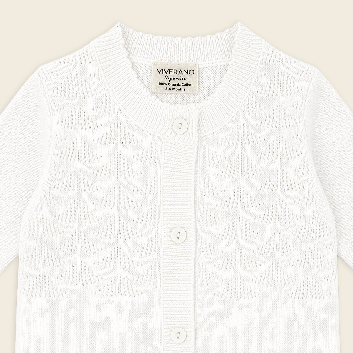 detail of milan dove white delicate pointelle knit baby jumpsuit made with organic cotton