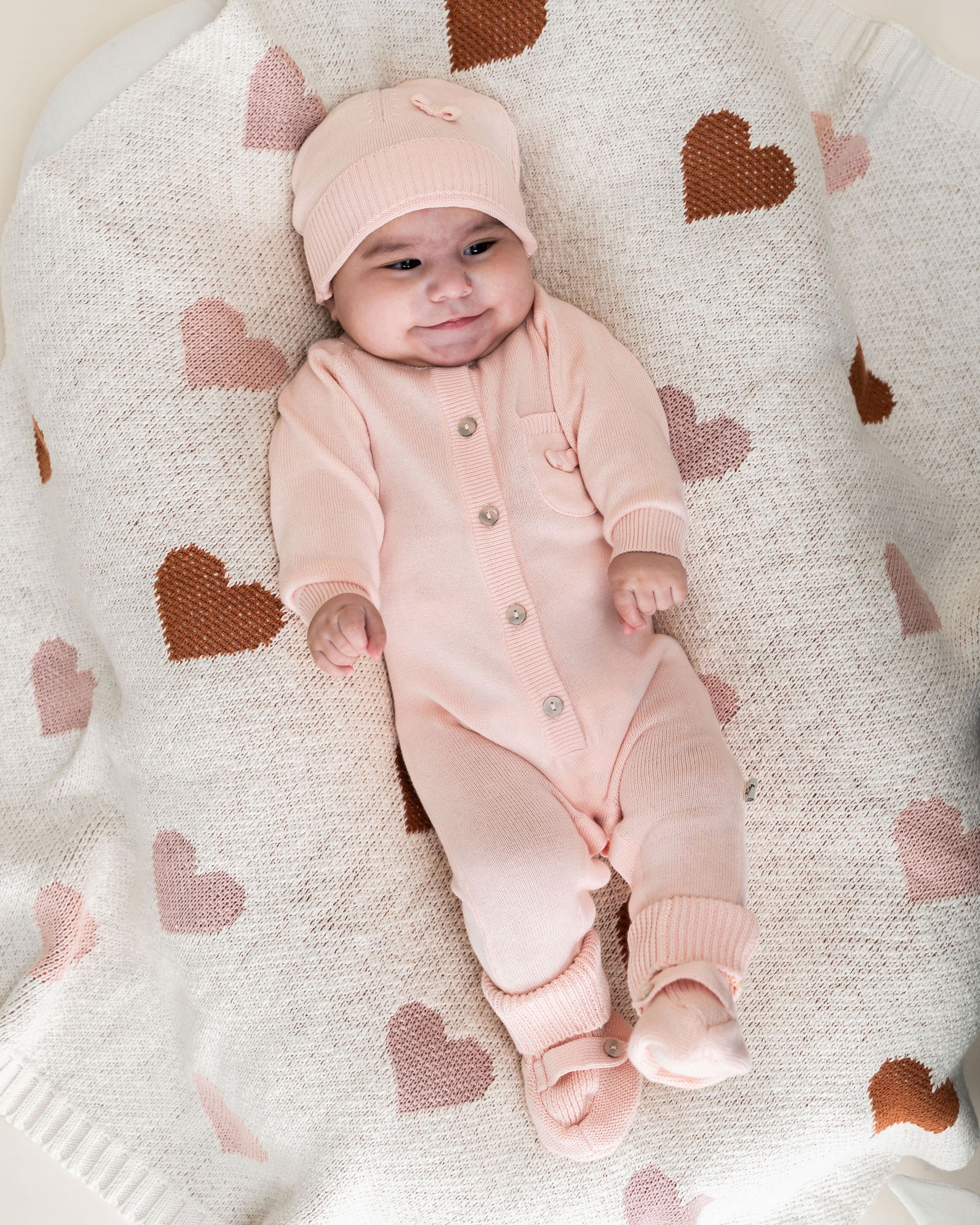 Loving Hearts - Organic Cotton Jacquard Sweater Knit Baby Blanket with model wearing Viverano Milan Outfit
