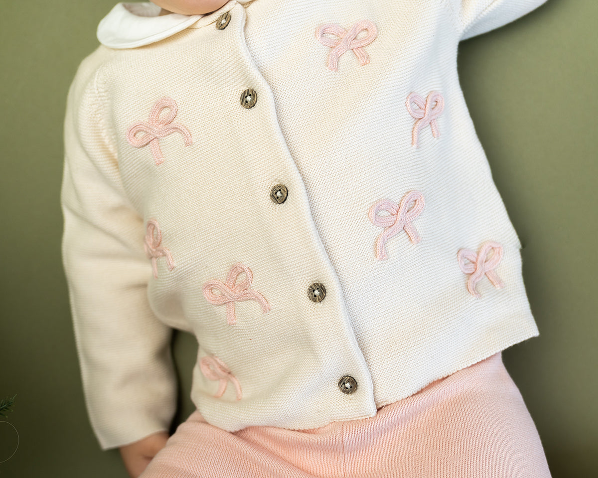 Viverano Organics baby cardigan in white with pink bow embroidery and button closure